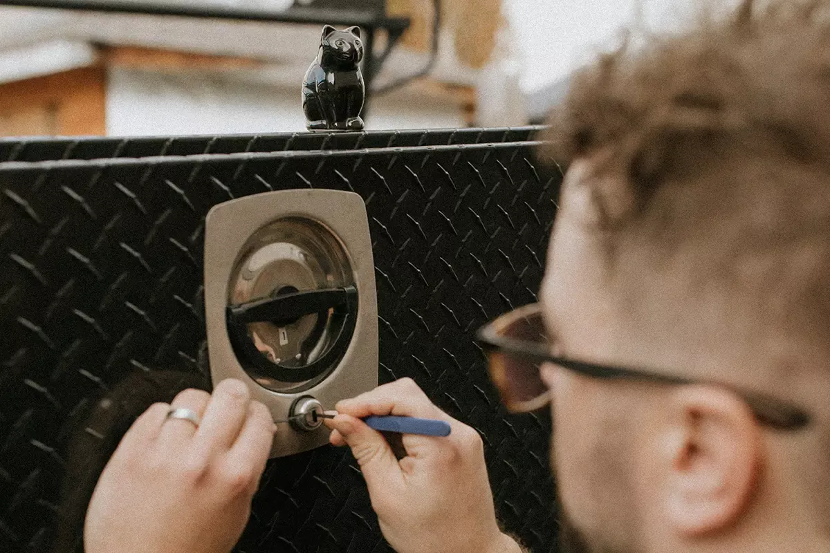 black cat lock and key - Automotive Locksmith working on a vehicle to open the back equipment box black cat lock and key - Automotive Locksmith working on a vehicle to open the back equipment box